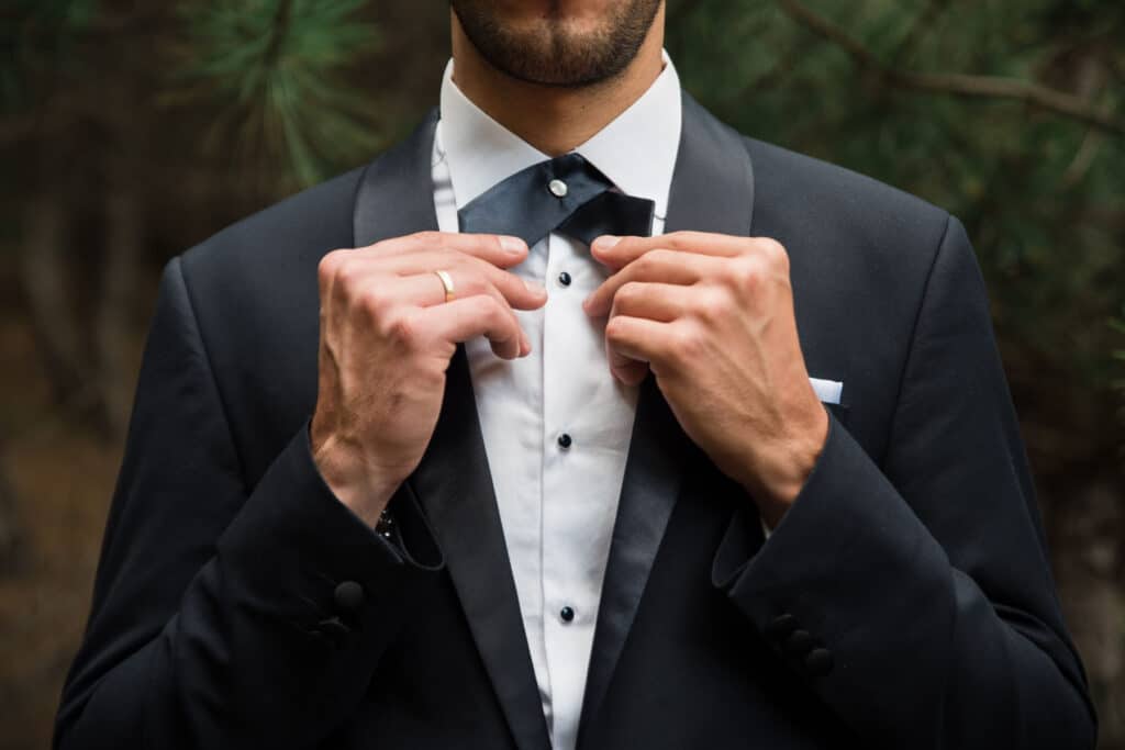corporate event experiences Groom at wedding tuxedo in the forest